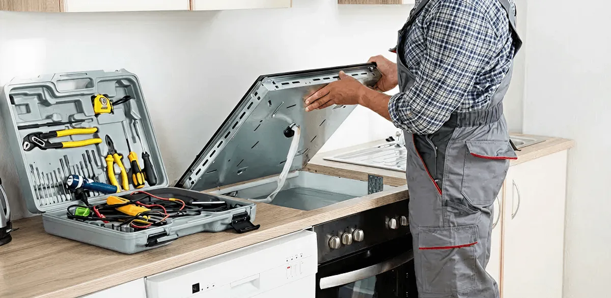 Handyman repairing a cooktop and checking wiring connections in Riverside, CA