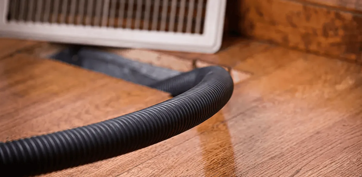 Air duct cleaning hose inserted into a floor vent for ductwork cleaning in Riverside, CA