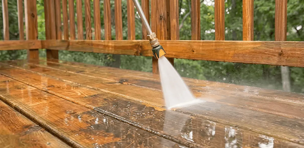 Pressure washing a wood deck to remove dirt and buildup in Riverside, CA